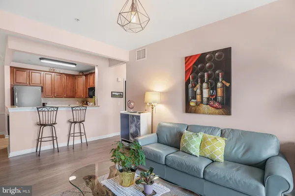 a living room with furniture and kitchen view