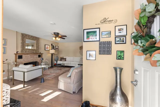 a living room with furniture a flat screen tv and a table