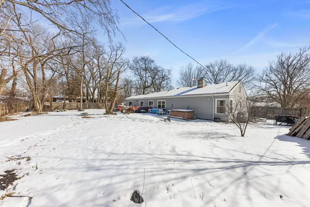 a view of a house with snow on the road