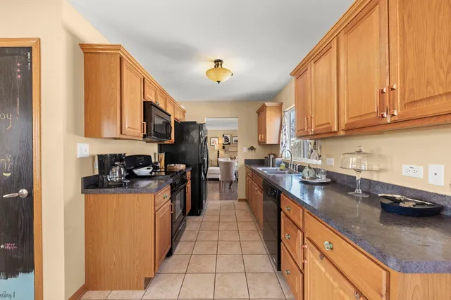 a kitchen with stainless steel appliances granite countertop a stove a sink dishwasher and a refrigerator