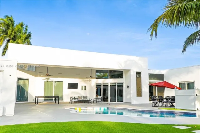 an aerial view of residential houses with outdoor space and street view
