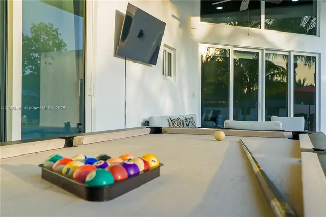 an aerial view of a house yard swimming pool and outdoor seating