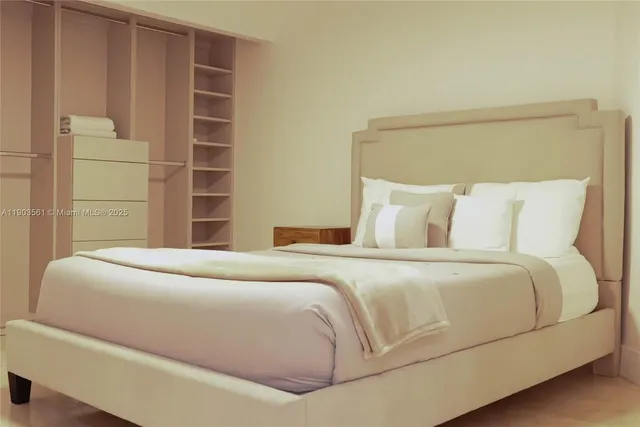 a bedroom with a bed and a night stand