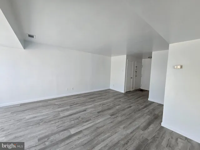 a view of an empty room and wooden floor
