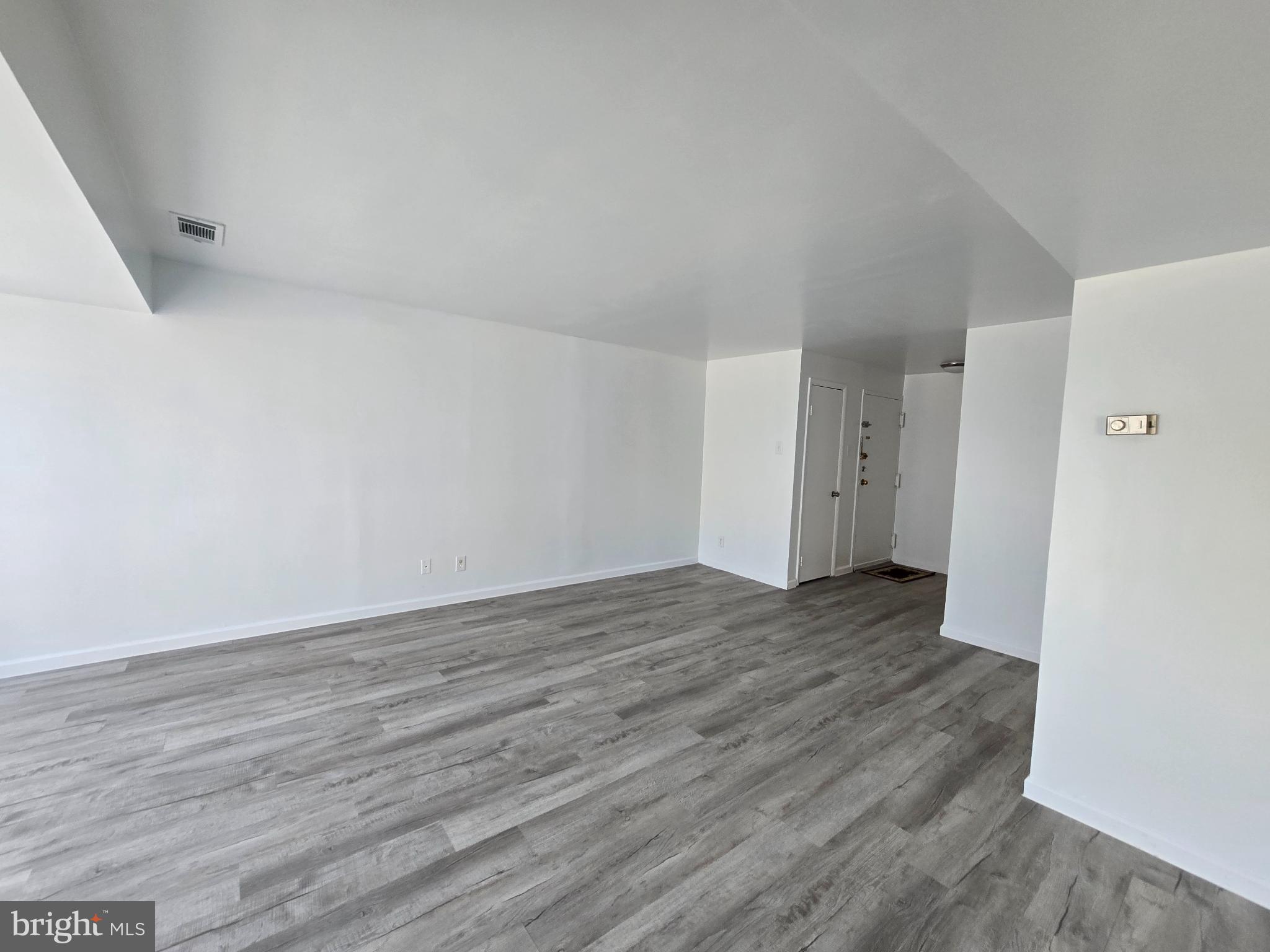 18901 Smoothstone Way, Unit I3 Gaithersburg, MD 20886 - Photo 14 of 36 a view of an empty room and wooden floor