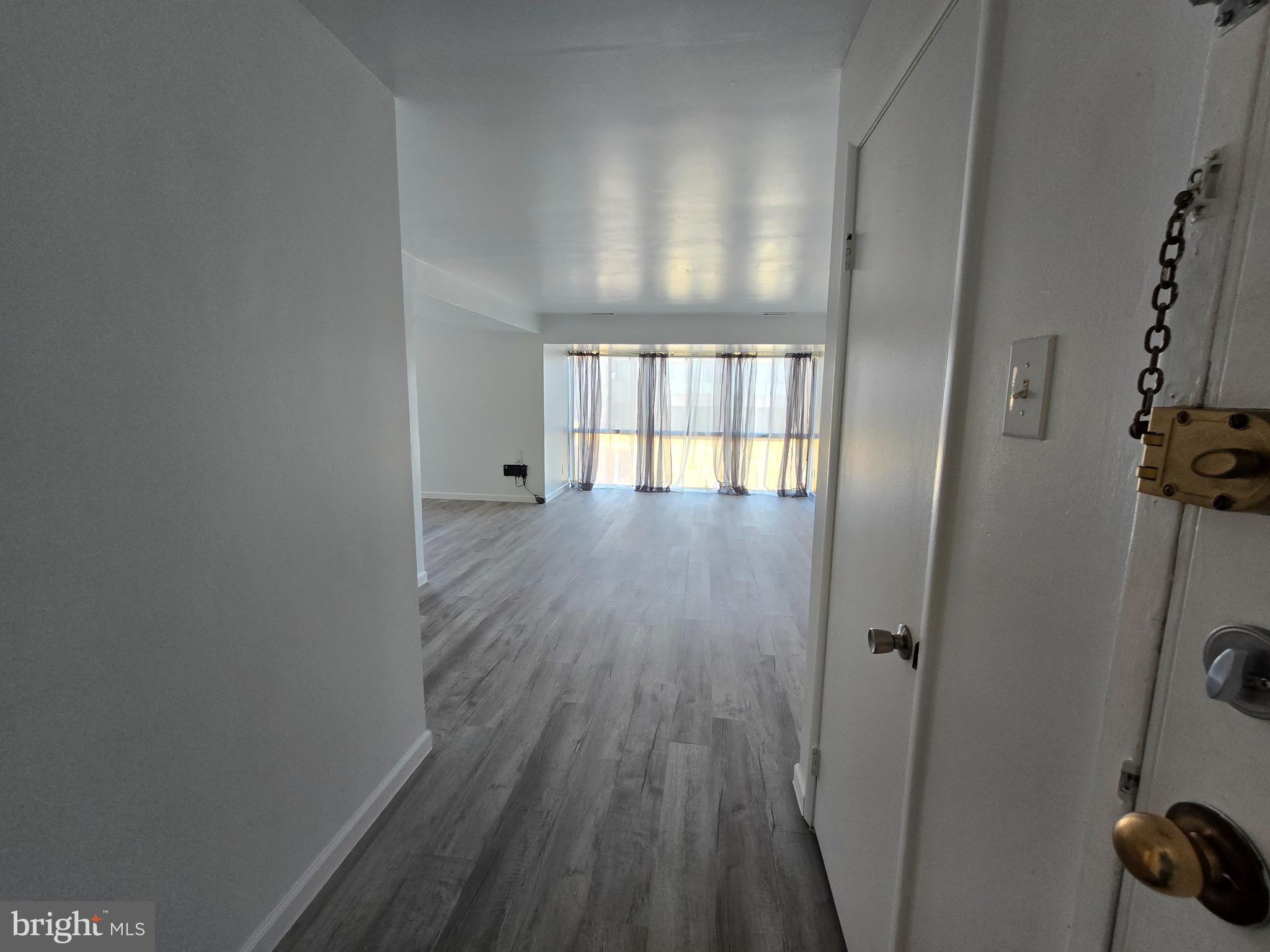 18901 Smoothstone Way, Unit I3 Gaithersburg, MD 20886 - Photo 17 of 36 wooden floor in an empty room with a window