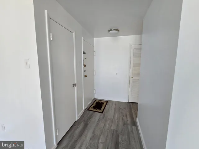 a view of a hallway with wooden floor