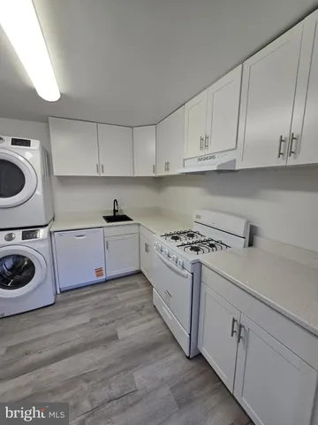 a kitchen with a stove top oven sink and cabinets