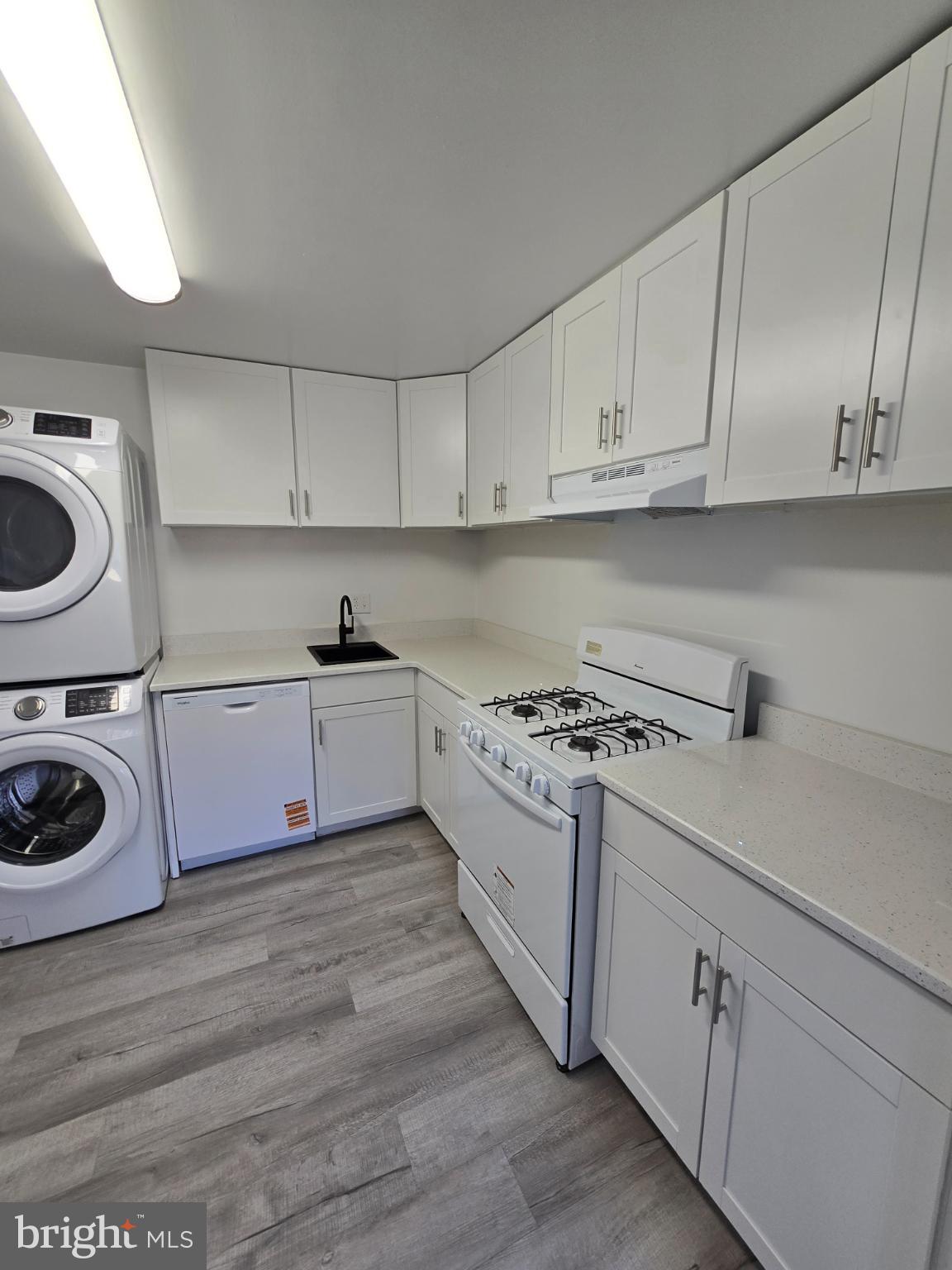 18901 Smoothstone Way, Unit I3 Gaithersburg, MD 20886 - Photo 2 of 36 a kitchen with a stove top oven sink and cabinets