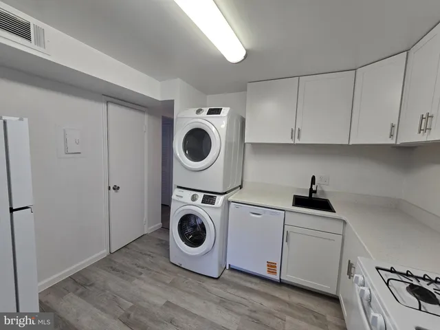 a kitchen with wooden cabinets and white appliances