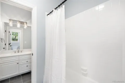 a spacious bathroom with a double vanity sink and a mirror