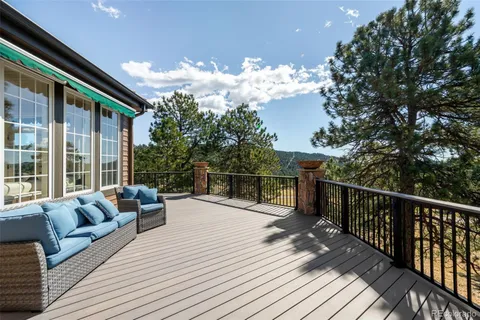 a balcony with furniture and wooden floor