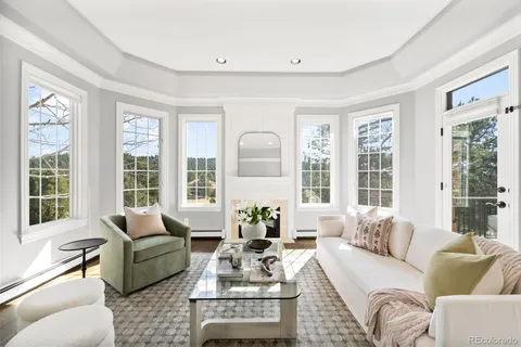 a living room with furniture and large windows