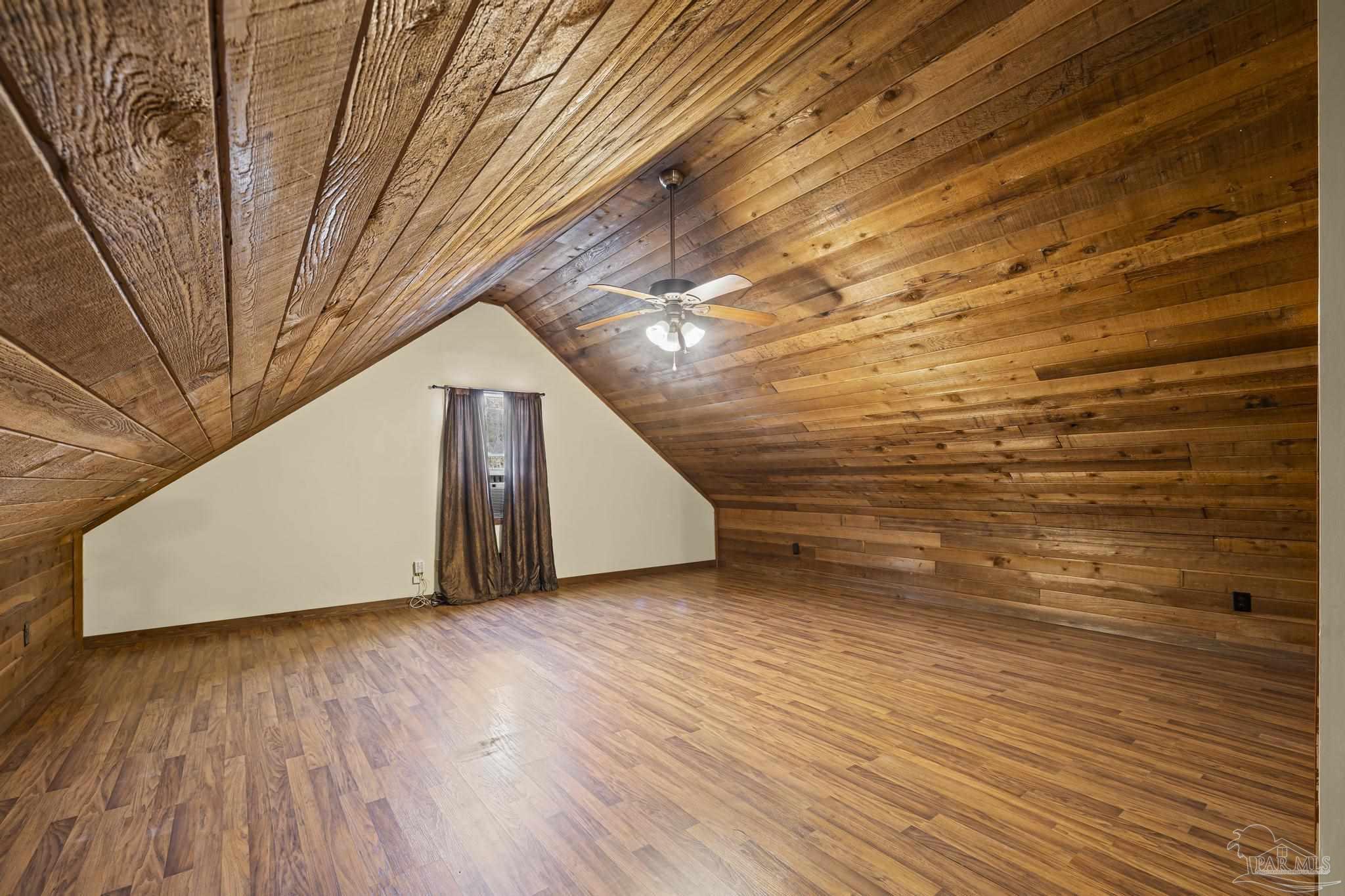 4960 Hyatt Lane Pace, FL 32571 - Photo 13 of 23 a view of a big room with wooden floor and windows