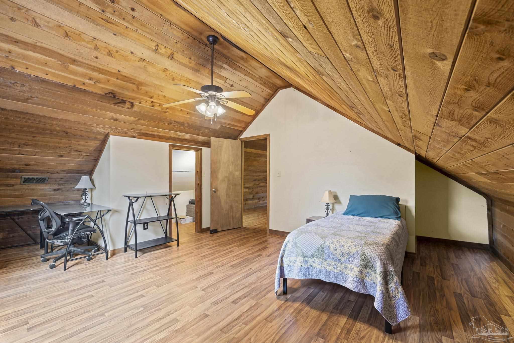 4960 Hyatt Lane Pace, FL 32571 - Photo 15 of 23 a bedroom with furniture and wooden floor