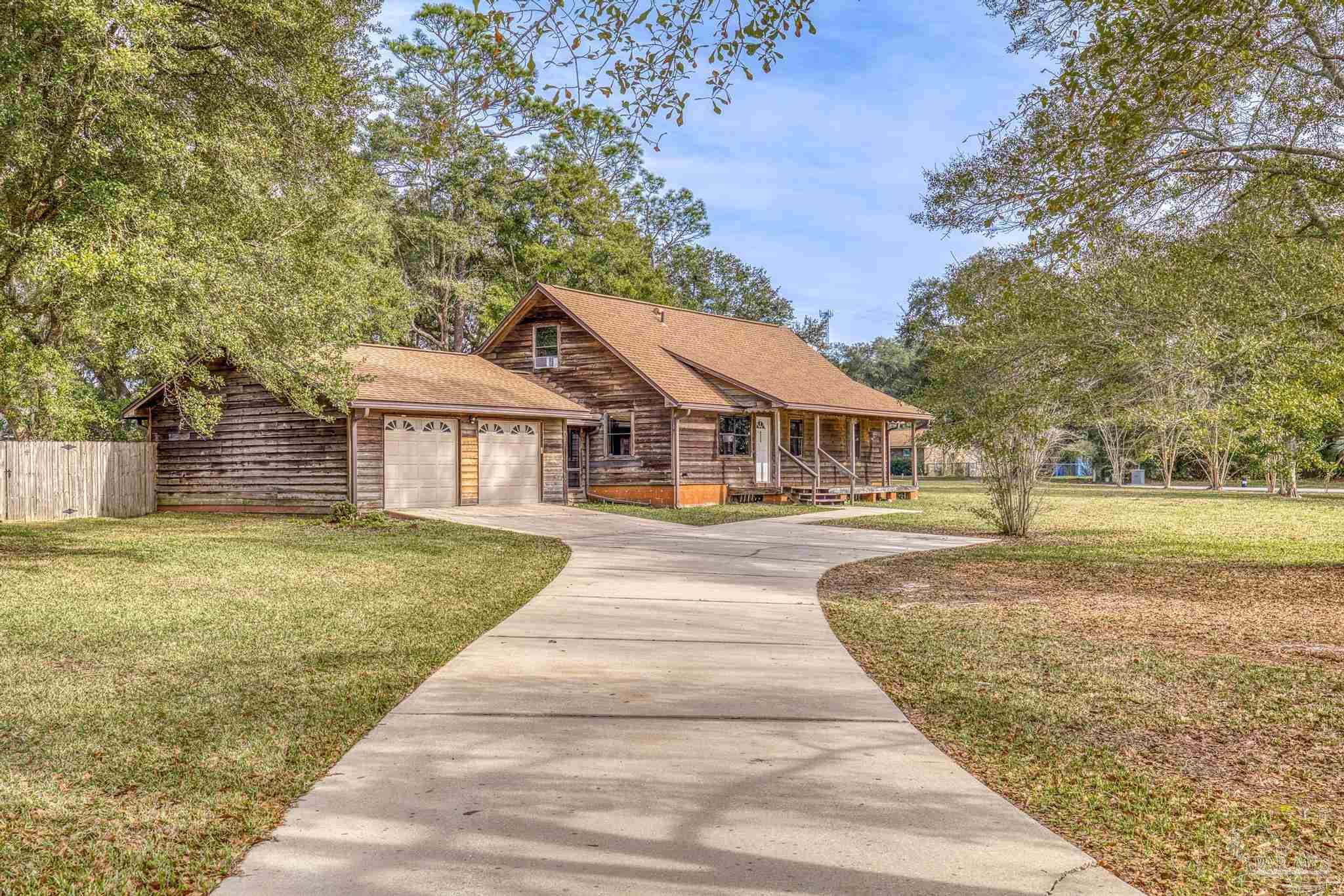 4960 Hyatt Lane Pace, FL 32571 - Photo 3 of 23 a front view of house with yard and green space