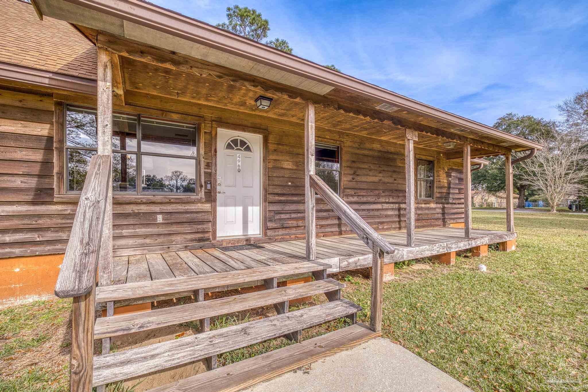 4960 Hyatt Lane Pace, FL 32571 - Photo 4 of 23 a view of a house with a door and a porch