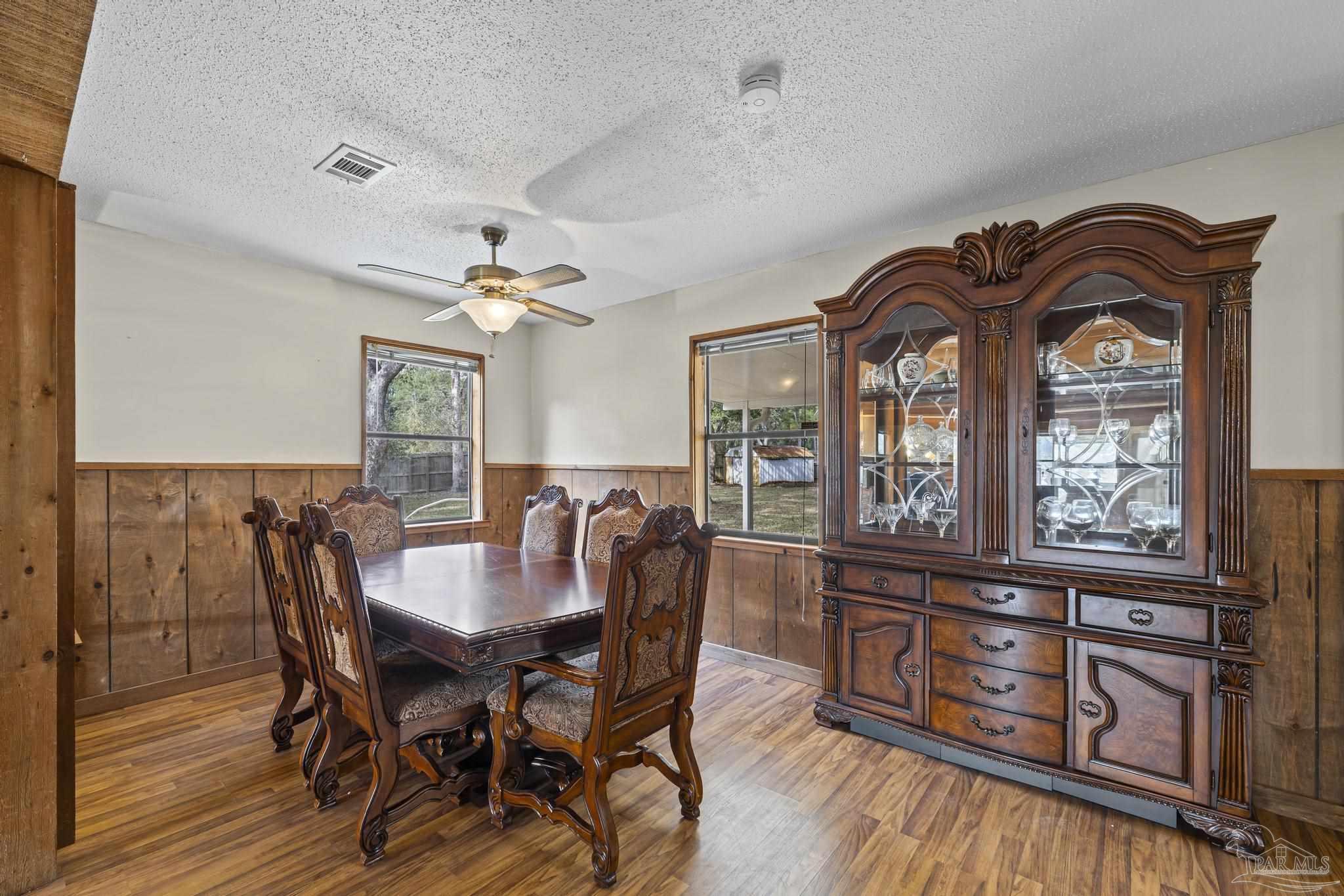 4960 Hyatt Lane Pace, FL 32571 - Photo 8 of 23 a view of a dining room with furniture a chandelier and wooden floor
