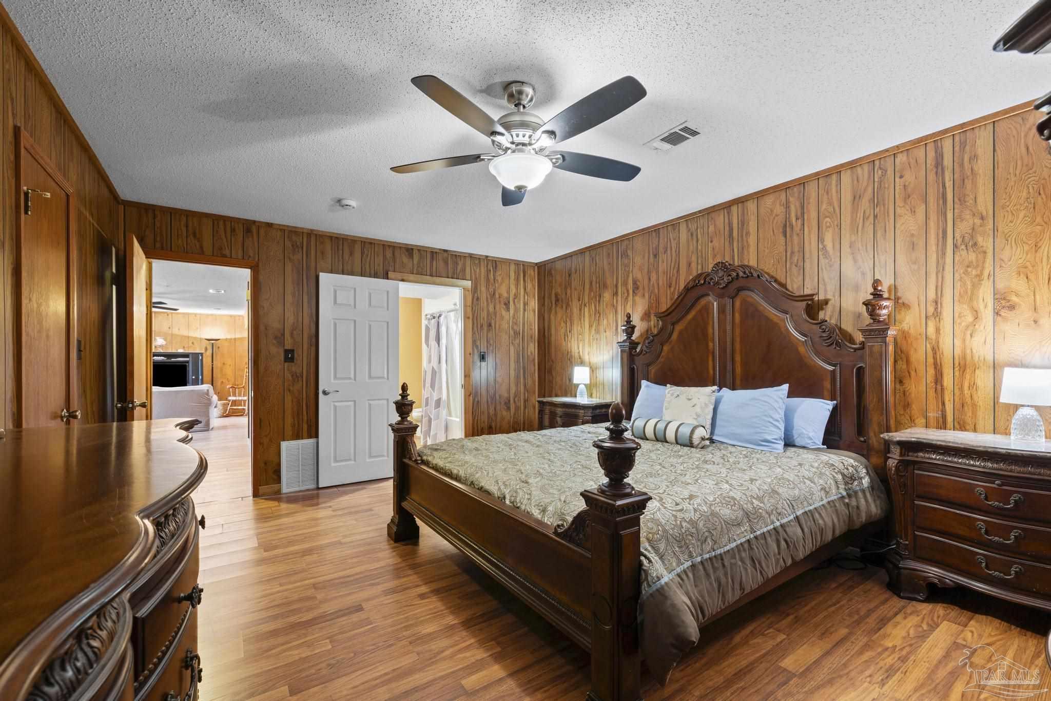 4960 Hyatt Lane Pace, FL 32571 - Photo 10 of 23 a bedroom with a bed and wooden floor