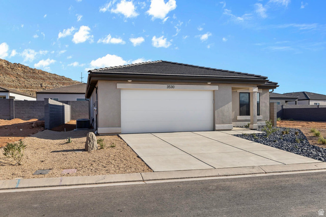 1597 South Fins Road, Unit 4177 Washington, UT 84780 - Photo 3 of 33 Single-story stucco exterior with an attached two-car garage, a concrete driveway, and a tiled roof