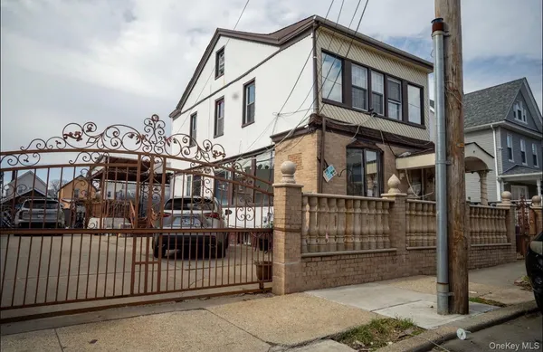 a view of a house with wooden fence