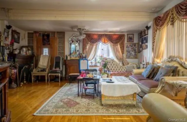 a living room with furniture a rug and a dining table
