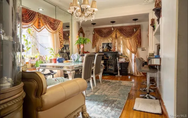 a living room with furniture a chandelier and a window
