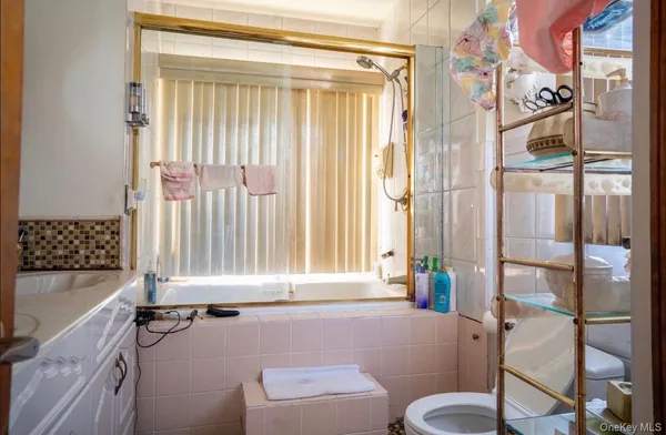 a bathroom with a granite countertop bathtub and a shower