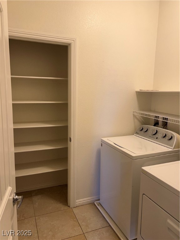 1070 Bobby Basin Avenue Henderson, NV 89014 - Photo 14 of 23 Laundry room with washer and dryer and light tile patterned floors