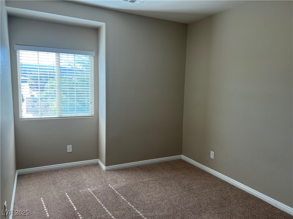 1070 Bobby Basin Avenue Henderson, NV 89014 - Photo 15 of 23 Unfurnished room with carpet floors and baseboards