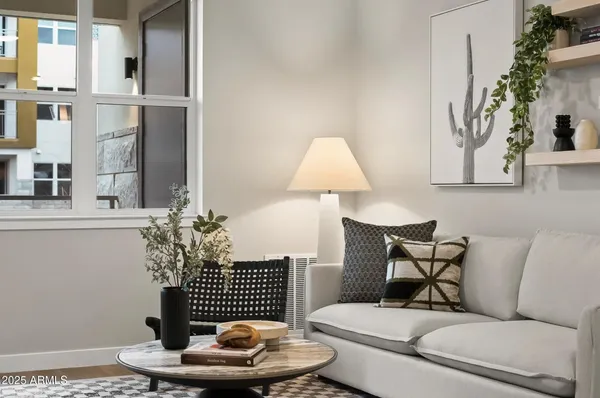 a living room with furniture and a potted plant