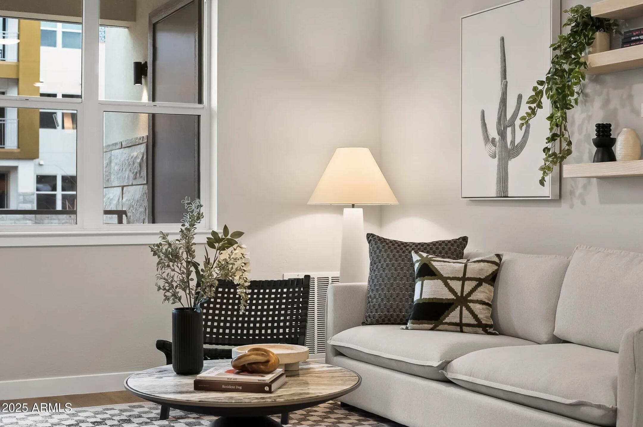 a living room with furniture and a potted plant