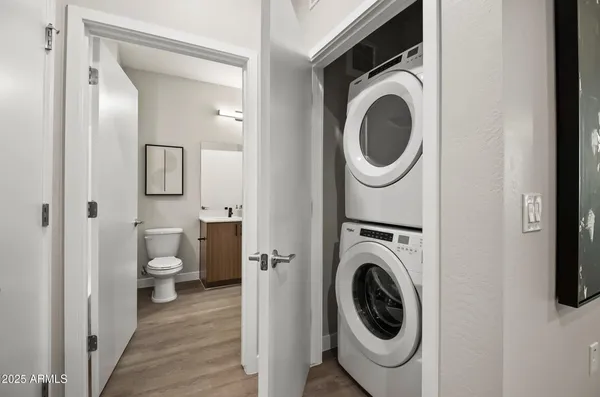 a kitchen with stainless steel appliances granite countertop a refrigerator a sink a stove and a refrigerator