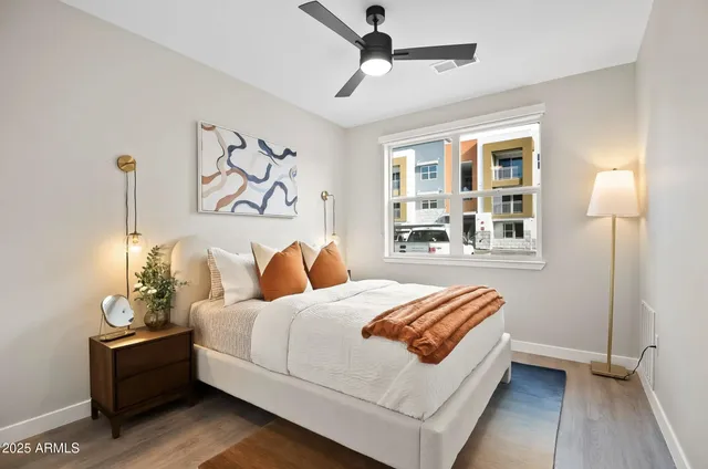 a bedroom with a bed and a painting on the wall