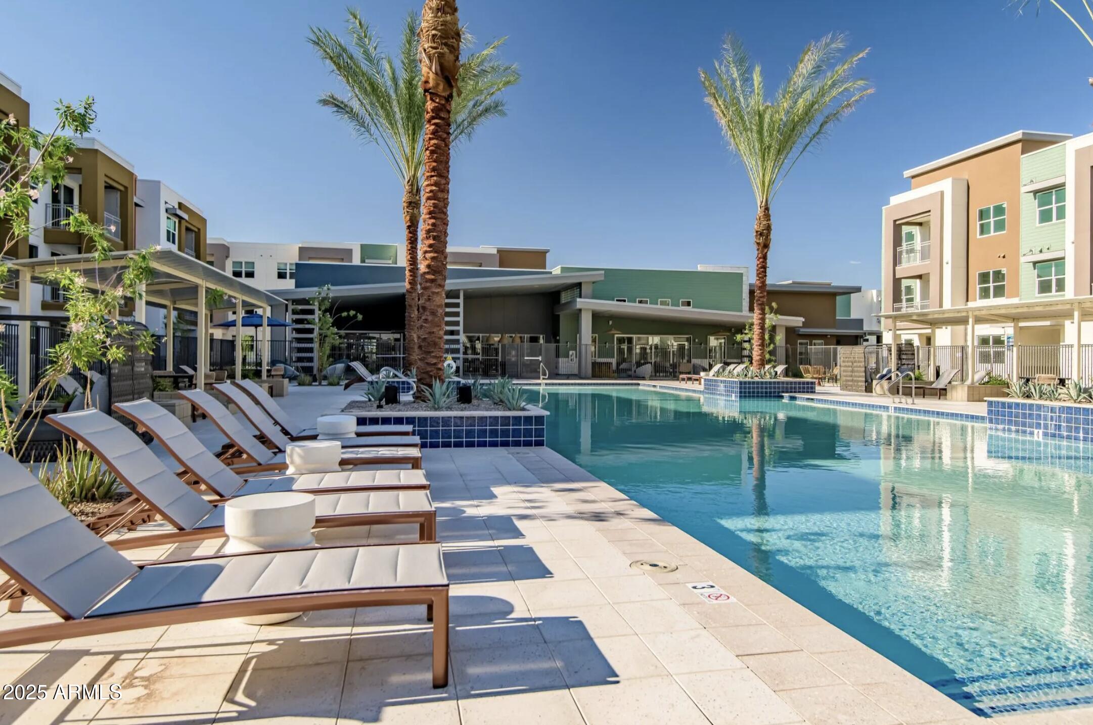 17445 West Lower Buckeye Road, Unit C1 Goodyear, AZ 85338 - Photo 32 of 35 a view of a swimming pool with a patio