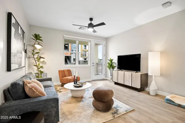 a living room with furniture and a large window