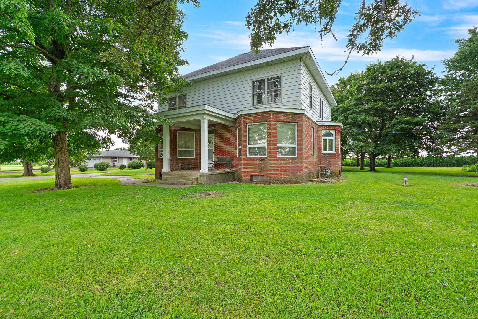 a front view of house with yard and green space