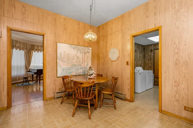 a view of a dining room with furniture and a chandelier