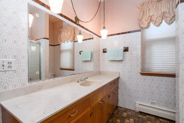 a bathroom with a sink a vanity and a mirror
