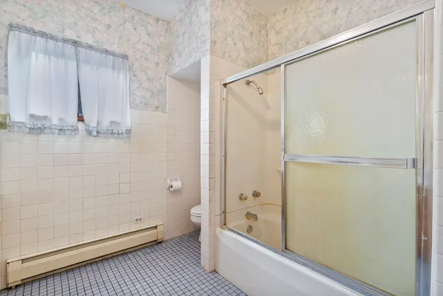 a bathroom with a shower and a tub