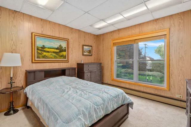 a bedroom with a large bed and a large window