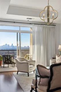 a living room with furniture and a floor to ceiling window