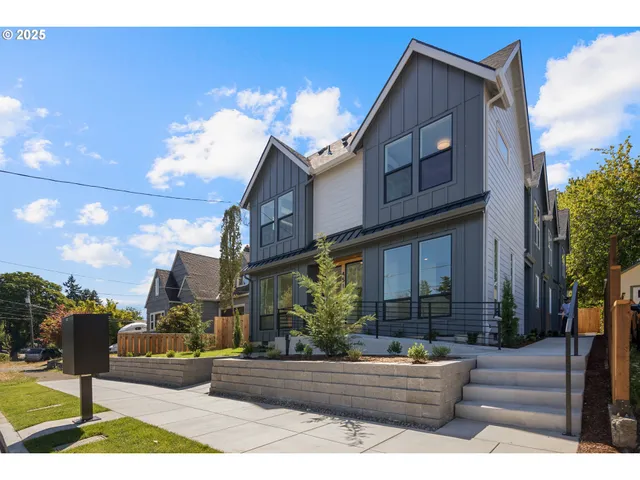 a front view of a house with garden and plants