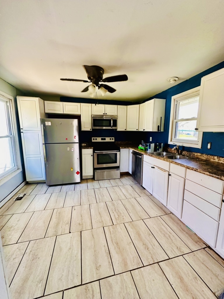 411 East Hamilton Street Odell, IL 60460 - Photo 9 of 19 a kitchen with stainless steel appliances kitchen island granite countertop a sink cabinets and window