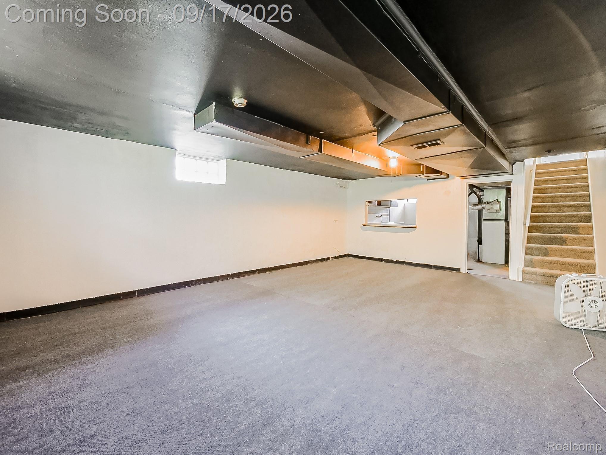 14102 Toepfer Road Warren, MI 48089 - Photo 19 of 39 Spacious finished lower level with painted ceiling, exposed ductwork, carpeted staircase, and a pass-through window