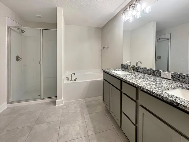a bathroom with a granite countertop sink a toilet and shower