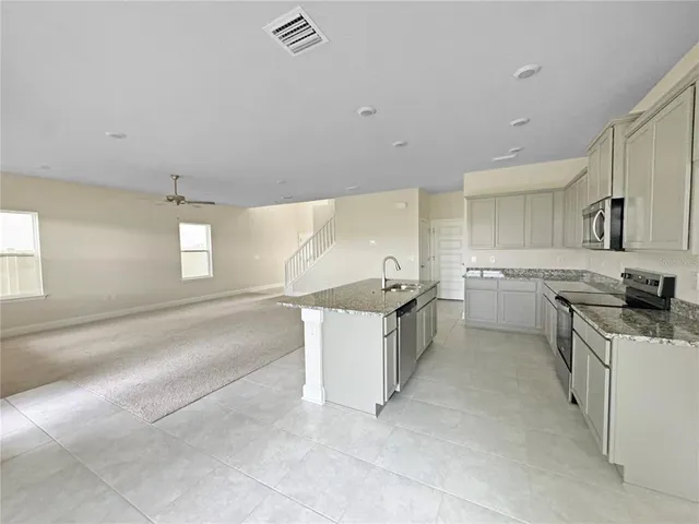 a kitchen with a sink stove and cabinets