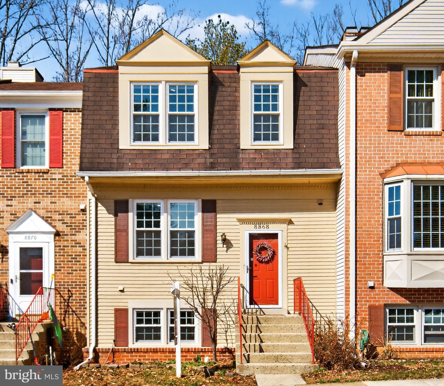 a front view of a residential apartment building with a yard