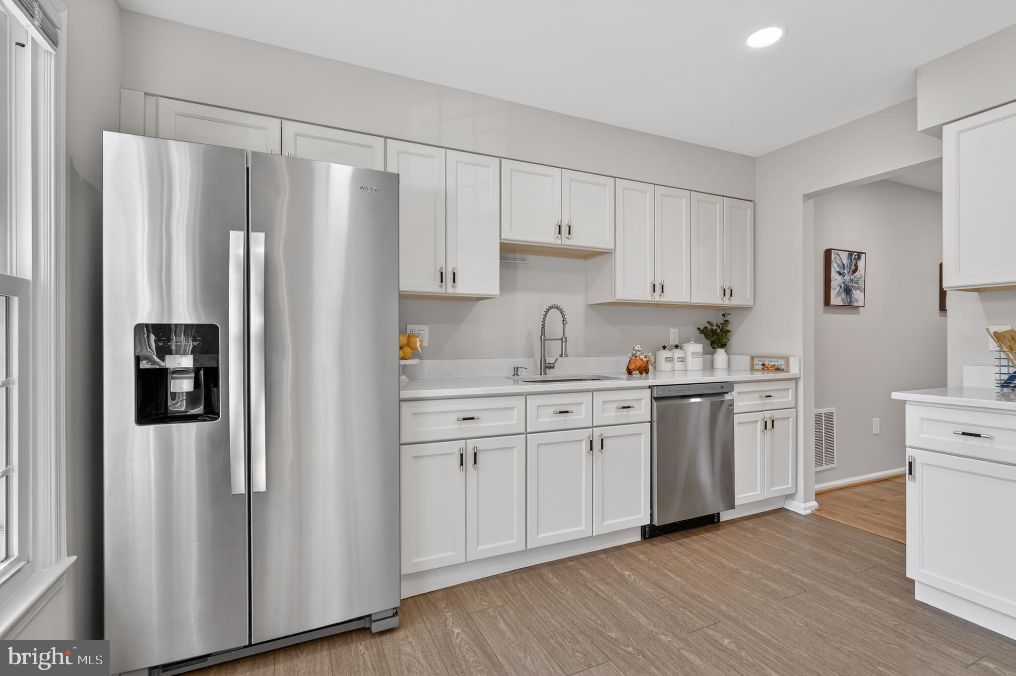 8868 Winding Hollow Way Springfield, VA 22152 - Photo 11 of 53 a kitchen with stainless steel appliances a refrigerator sink and cabinets