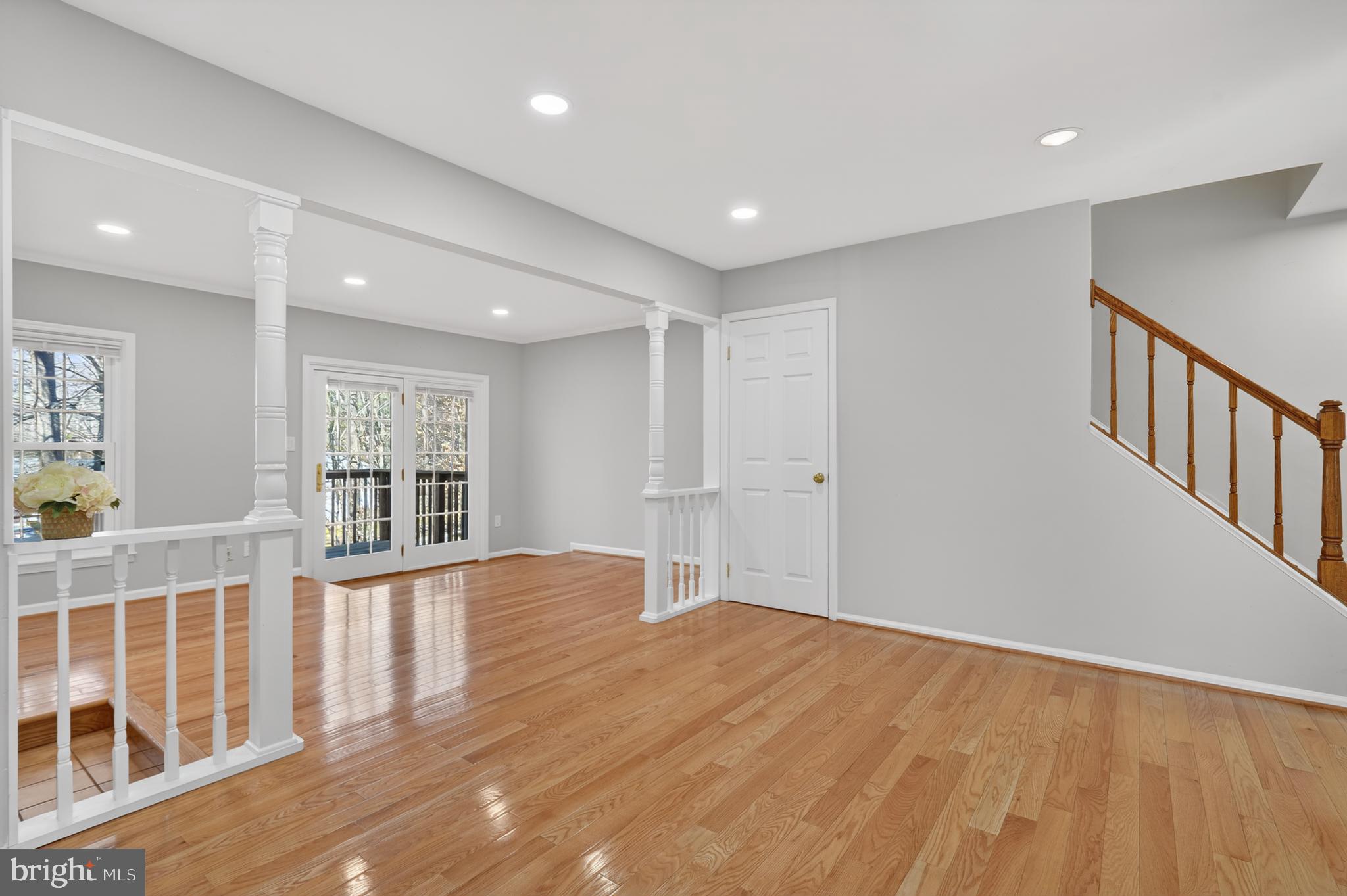 8868 Winding Hollow Way Springfield, VA 22152 - Photo 13 of 53 a view of an empty room with wooden floor and windows